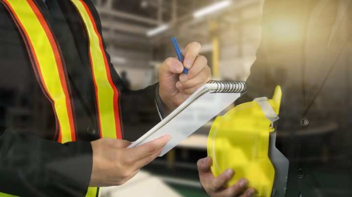 engineers at work with notepads - CHAS workplace safety