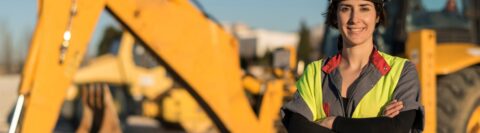 female engineer with a tractor in the background