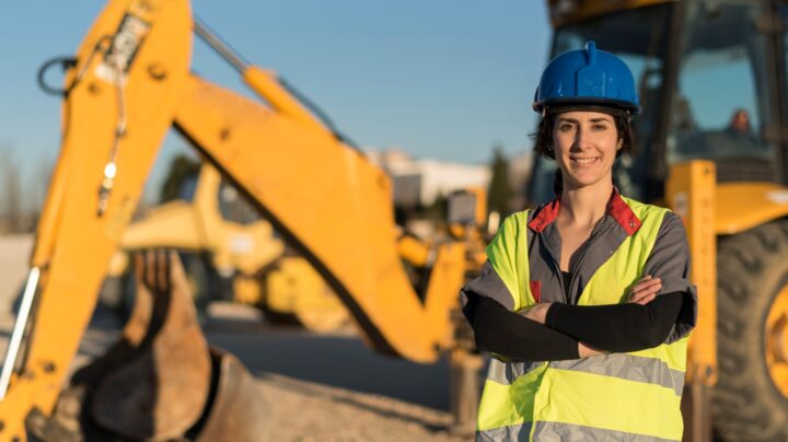 female engineer with a tractor in the background