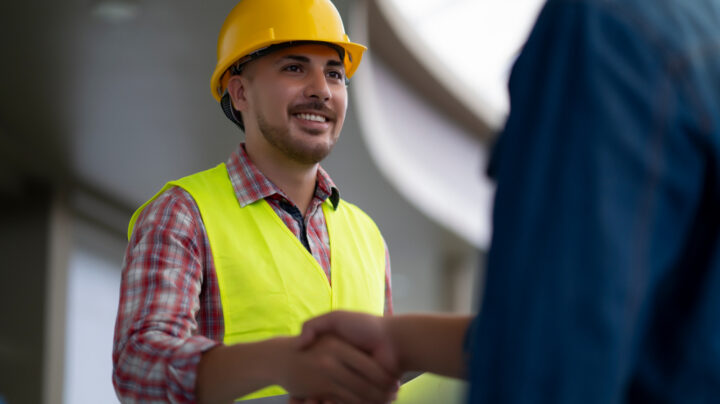 Engineer with a hard hat and And Customer Shaking Hands Having Agreement Success Working