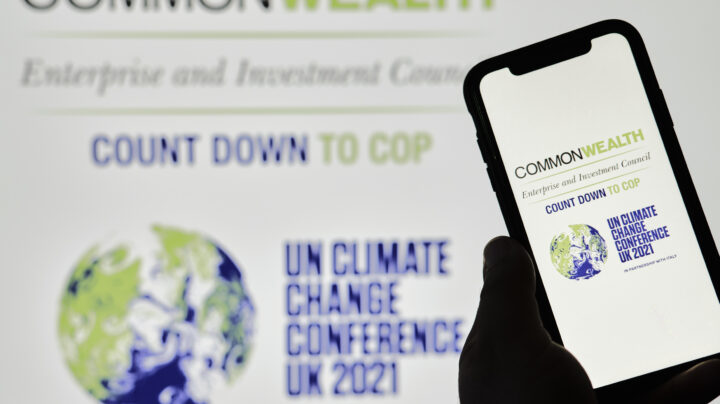 Hand holds a phone with COP26 logo