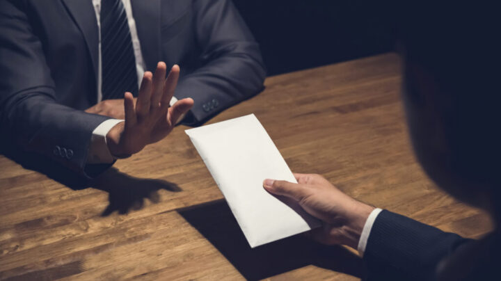 Businessman Rejecting Money In White Envelope