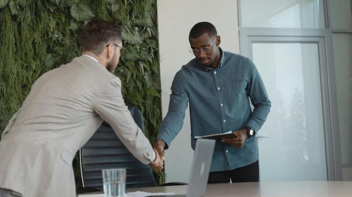 men shaking hands meeting office