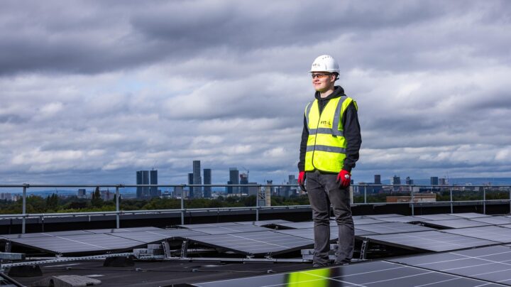 worker on solar roof panel