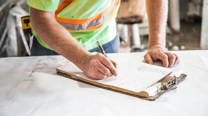person going through clipboard checklist