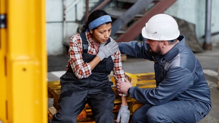 woman hurt in warehouse, man helping her