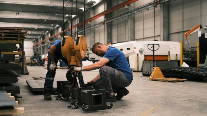 industrial workers operating machinery in factory